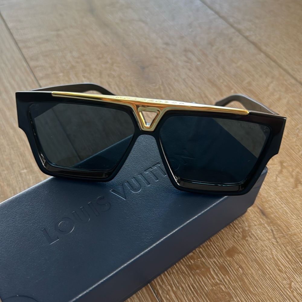 Women’s Louis Viutton black frame sunglasses with gold accent